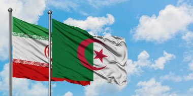 İran ve Cezayir bayrağı birlikte beyaz bulutlu mavi gökyüzüne karşı rüzgarda sallayarak. Diplomasi kavramı, uluslararası ilişkiler.