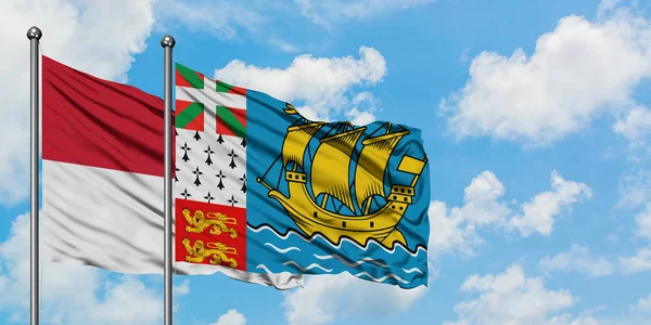 Iraq and Saint Pierre And Miquelon flag waving in the wind against white cloudy blue sky together. Diplomacy concept, international relations. — Stock Photo, Image