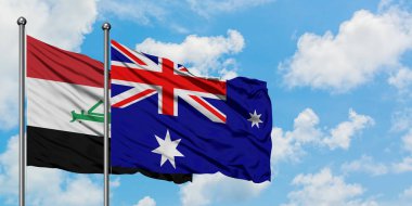 Irak ve Heard Adası ve Mcdonald Adaları bayrağı birlikte beyaz bulutlu mavi gökyüzüne karşı rüzgarda sallayarak. Diplomasi kavramı, uluslararası ilişkiler.