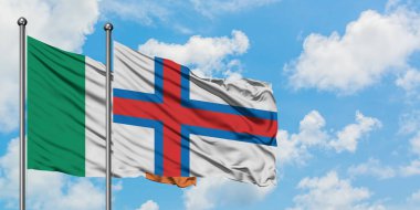 İrlanda ve Faroe Adaları bayrağı birlikte beyaz bulutlu mavi gökyüzüne karşı rüzgarda sallayarak. Diplomasi kavramı, uluslararası ilişkiler.