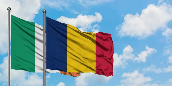 Ireland and Chad flag waving in the wind against white cloudy blue sky together. Diplomacy concept, international relations. — Stock Photo, Image