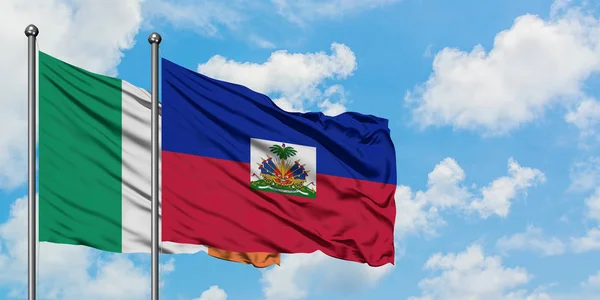 Ireland and Haiti flag waving in the wind against white cloudy blue sky together. Diplomacy concept, international relations. — Stock Photo, Image