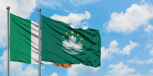 Ireland and Macao flag waving in the wind against white cloudy blue sky together. Diplomacy concept, international relations.