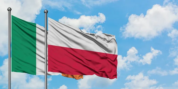 Ireland and Poland flag waving in the wind against white cloudy blue sky together. Diplomacy concept, international relations.