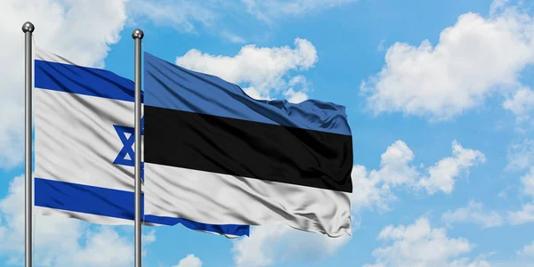 Bandera de Israel y Estonia ondeando en el viento contra el cielo azul nublado blanco juntos. Concepto diplomático, relaciones internacionales . — Foto de Stock