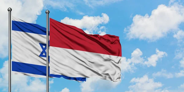 Ізраїль і Індонезія прапор розмахуючи в вітру проти білого хмарного синього неба разом. Концепція дипломатії, міжнародні відносини. — стокове фото