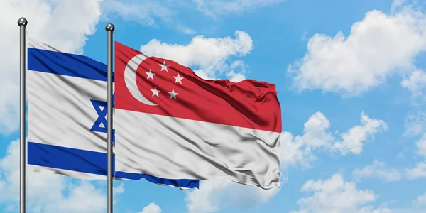 Israel and Singapore flag waving in the wind against white cloudy blue sky together. Diplomacy concept, international relations. — Stock Photo, Image