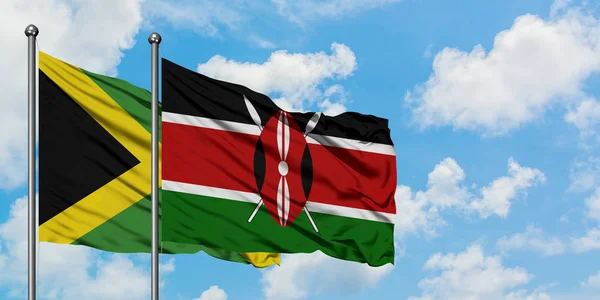 Bandera de Jamaica y Kenia ondeando en el viento contra el cielo azul nublado blanco juntos. Concepto diplomático, relaciones internacionales . —  Fotos de Stock