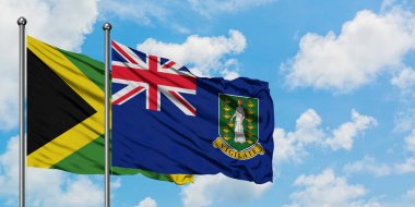 Jamaika ve İngiliz Virgin Adaları bayrağı birlikte beyaz bulutlu mavi gökyüzüne karşı rüzgarda sallayarak. Diplomasi kavramı, uluslararası ilişkiler.