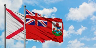 Jersey ve Bermuda bayrağı birlikte beyaz bulutlu mavi gökyüzüne karşı rüzgarda sallayarak. Diplomasi kavramı, uluslararası ilişkiler.