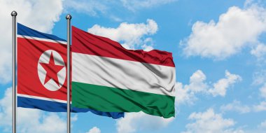 Kuzey Kore ve Macaristan bayrağı birlikte beyaz bulutlu mavi gökyüzüne karşı rüzgarsal sallayarak. Diplomasi kavramı, uluslararası ilişkiler.