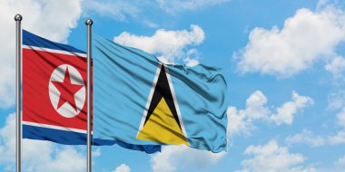 Kuzey Kore ve Saint Lucia bayrağı birlikte beyaz bulutlu mavi gökyüzüne karşı rüzgarda sallayarak. Diplomasi kavramı, uluslararası ilişkiler.