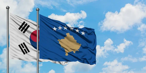 Güney Kore ve Kosova bayrağı birlikte beyaz bulutlu mavi gökyüzüne karşı rüzgarda sallayarak. Diplomasi kavramı, uluslararası ilişkiler. — Stok fotoğraf