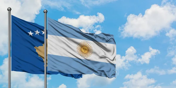 Η σημαία του Κοσσυφοπεδίου και της Αργεντινής χαιρετάει τον άνεμο ενάντια στον λευκό συννεφιασμένο γαλάζιο ουρανό. Φιλοσοφία της διπλωματίας, διεθνείς σχέσεις. — Φωτογραφία Αρχείου