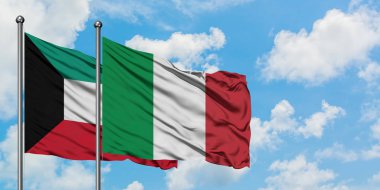 Kuveyt ve İtalya bayrağı birlikte beyaz bulutlu mavi gökyüzüne karşı rüzgarsal sallayarak. Diplomasi kavramı, uluslararası ilişkiler.