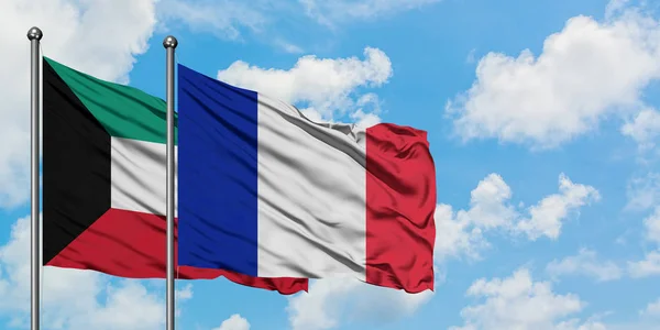 Kuwait and France flag waving in the wind against white cloudy blue sky together. Diplomacy concept, international relations. — Stock Photo, Image