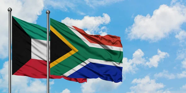 Kuwait and South Africa flag waving in the wind against white cloudy blue sky together. Diplomacy concept, international relations. — Stock Photo, Image