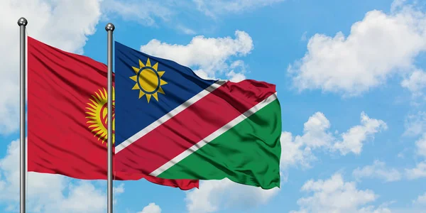 Kirgizië en Namibië vlag zwaaien in de wind tegen witte bewolkte blauwe hemel samen. Diplomatie concept, internationale betrekkingen. — Stockfoto