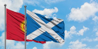 Kırgızistan ve İskoçya bayrağı birlikte beyaz bulutlu mavi gökyüzüne karşı rüzgarda sallayarak. Diplomasi kavramı, uluslararası ilişkiler.