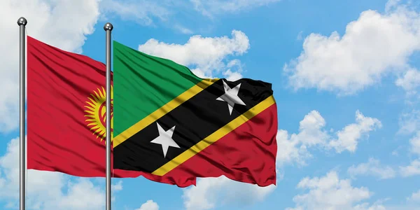 Kyrgyzstan and Saint Kitts And Nevis flag waving in the wind against white cloudy blue sky together. Diplomacy concept, international relations. — Stock Photo, Image