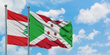 Lübnan ve Burundi bayrağı birlikte beyaz bulutlu mavi gökyüzüne karşı rüzgarda sallayarak. Diplomasi kavramı, uluslararası ilişkiler.