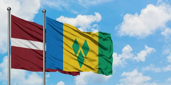 Letonya ve Saint Vincent ve Grenadinler bayrağı birlikte beyaz bulutlu mavi gökyüzüne karşı rüzgarda sallayarak. Diplomasi kavramı, uluslararası ilişkiler. — Stok fotoğraf