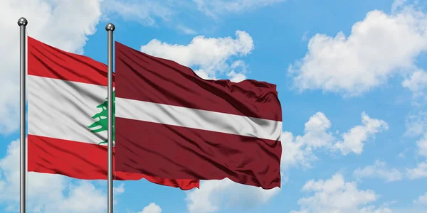 Lebanon and Latvia flag waving in the wind against white cloudy blue sky together. Diplomacy concept, international relations. — 스톡 사진