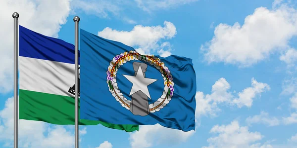 Lesotho and Northern Mariana Islands flag waving in the wind against white cloudy blue sky together. Diplomacy concept, international relations. — Stock Photo, Image