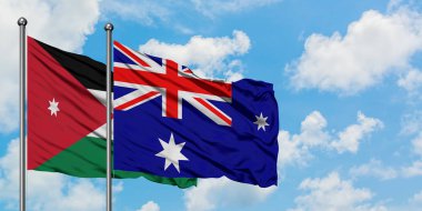 Ürdün ve Heard Adası ve Mcdonald Adaları bayrağı birlikte beyaz bulutlu mavi gökyüzüne karşı rüzgarda sallayarak. Diplomasi kavramı, uluslararası ilişkiler.