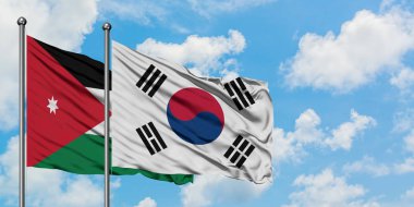 Ürdün ve Güney Kore bayrağı birlikte beyaz bulutlu mavi gökyüzüne karşı rüzgarda sallayarak. Diplomasi kavramı, uluslararası ilişkiler.