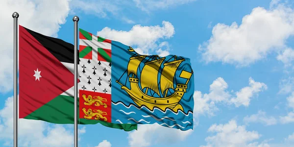 Jordania y San Pedro Y Miquelón bandera ondeando en el viento contra blanco cielo azul nublado juntos. Concepto diplomático, relaciones internacionales . — Foto de Stock