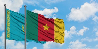 Kazakistan ve Kamerun bayrağı birlikte beyaz bulutlu mavi gökyüzüne karşı rüzgarsal sallayarak. Diplomasi kavramı, uluslararası ilişkiler.