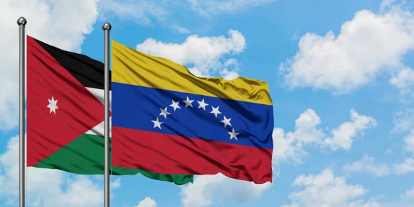 Jordan and Venezuela flag waving in the wind against white cloudy blue sky together. Diplomacy concept, international relations. — Stock Photo, Image
