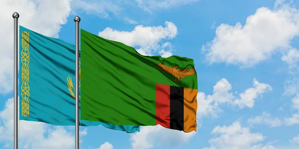 Kazakhstan and Zambia flag waving in the wind against white cloudy blue sky together. Diplomacy concept, international relations. — Stock Photo, Image