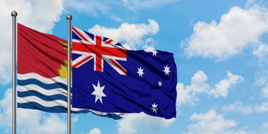 Kiribati ve Avustralya bayrağı birlikte beyaz bulutlu mavi gökyüzüne karşı rüzgarda sallayarak. Diplomasi kavramı, uluslararası ilişkiler.