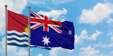 Kiribati ve Heard Adası ve Mcdonald Adaları bayrağı birlikte beyaz bulutlu mavi gökyüzüne karşı rüzgarda sallayarak. Diplomasi kavramı, uluslararası ilişkiler.