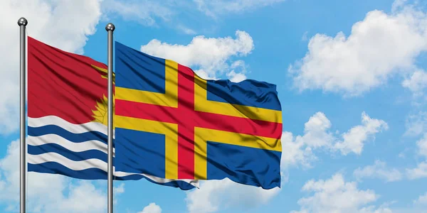 Kiribati and Aland Islands flag waving in the wind against white cloudy blue sky together. Diplomacy concept, international relations. — Stock Photo, Image