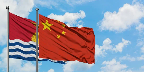 Kiribati e la bandiera cinese sventolano insieme nel vento contro il bianco cielo blu nuvoloso. Concetto di diplomazia, relazioni internazionali . — Foto Stock