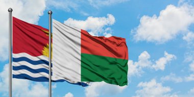 Kiribati ve Madagaskar bayrağı birlikte beyaz bulutlu mavi gökyüzüne karşı rüzgarda sallayarak. Diplomasi kavramı, uluslararası ilişkiler.