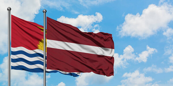 Kiribati and Latvia flag waving in the wind against white cloudy blue sky together. Diplomacy concept, international relations.