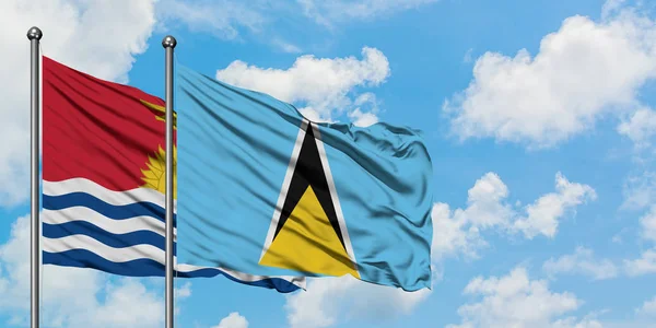 Kiribati y Santa Lucía ondeando en el viento contra el cielo azul nublado blanco juntos. Concepto diplomático, relaciones internacionales . — Foto de Stock