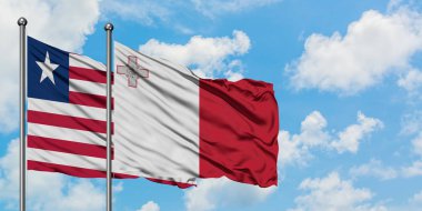 Liberya ve Malta bayrağı birlikte beyaz bulutlu mavi gökyüzüne karşı rüzgarda sallayarak. Diplomasi kavramı, uluslararası ilişkiler.