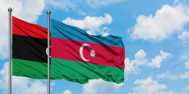 Libya ve Azerbaycan bayrağı havada havada sallanıyor. Diplomasi kavramı, uluslararası ilişkiler.