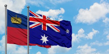 Liechtenstein ve Heard Adası ve Mcdonald Adaları bayrağı birlikte beyaz bulutlu mavi gökyüzüne karşı rüzgarda sallayarak. Diplomasi kavramı, uluslararası ilişkiler.