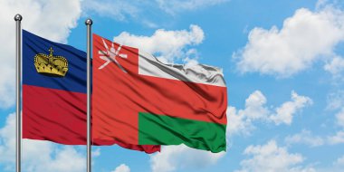 Liechtenstein ve Umman bayrağı birlikte beyaz bulutlu mavi gökyüzüne karşı rüzgarda sallayarak. Diplomasi kavramı, uluslararası ilişkiler.