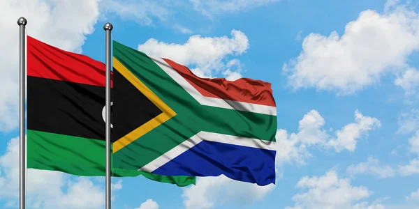 Libya and South Africa flag waving in the wind against white cloudy blue sky together. Diplomacy concept, international relations. — Stock Photo, Image