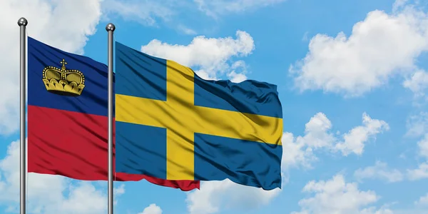 Liechtenstein and Sweden flag waving in the wind against white cloudy blue sky together. Diplomacy concept, international relations. — Stock Photo, Image
