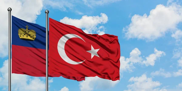 Liechtenstein and Turkey flag waving in the wind against white cloudy blue sky together. Diplomacy concept, international relations. — Stock Photo, Image