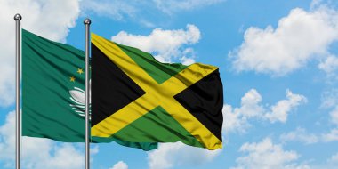 Macao ve Jamaika bayrağı birlikte beyaz bulutlu mavi gökyüzüne karşı rüzgarda sallayarak. Diplomasi kavramı, uluslararası ilişkiler.