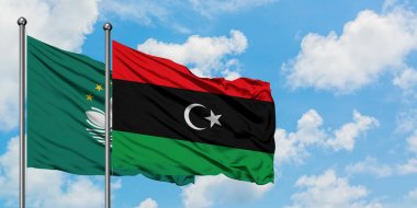 Macao ve Libya bayrağı birlikte beyaz bulutlu mavi gökyüzüne karşı rüzgarda sallayarak. Diplomasi kavramı, uluslararası ilişkiler.